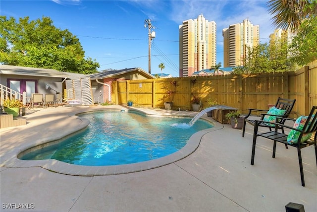view of pool with french doors, a patio area, a fenced in pool, and a fenced backyard
