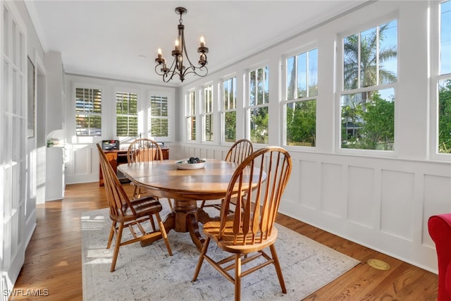 sunroom featuring a notable chandelier and french doors