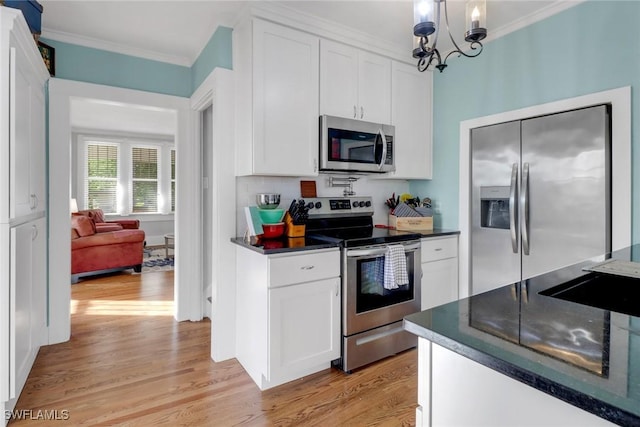 kitchen featuring ornamental molding, stainless steel appliances, and light wood-style flooring
