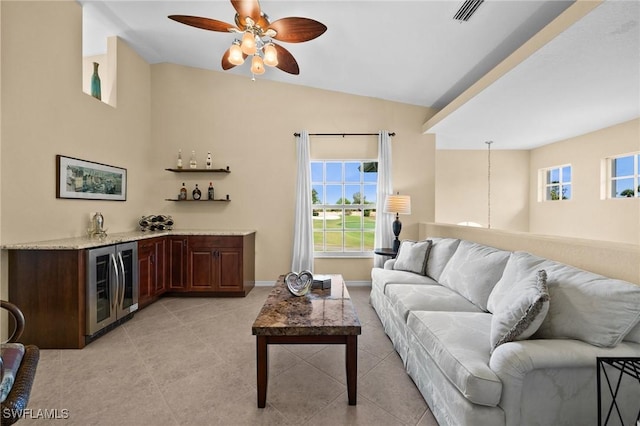 6095 Pinnacle Ln Unit 1304, Naples, FL 34110 - living area with beverage cooler, vaulted ceiling, visible vents, ceiling fan, and bar