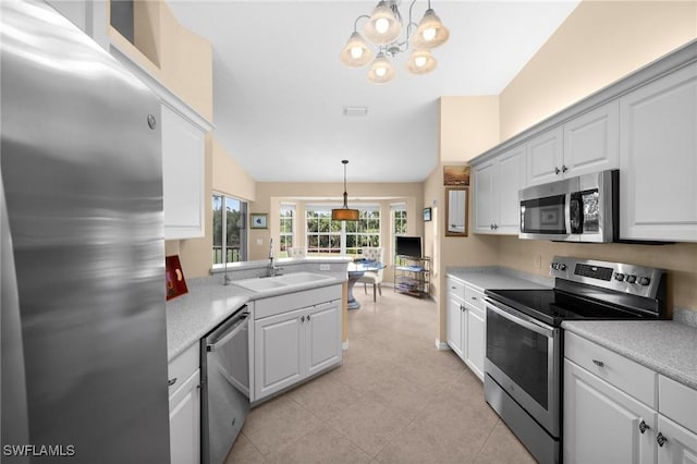 6095 Pinnacle Ln Unit 1304, Naples, FL 34110 - kitchen with light countertops, a peninsula, stainless steel appliances, and a sink