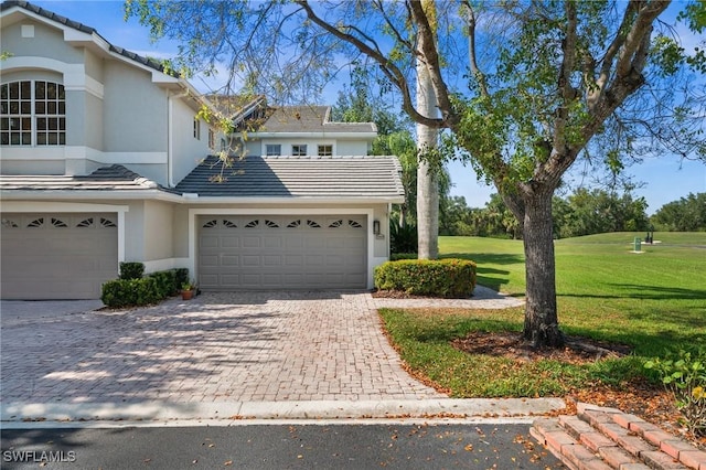 6095 Pinnacle Ln Unit 1304, Naples, FL 34110 - view of front of property featuring a tile roof, a front yard, stucco siding, and decorative driveway