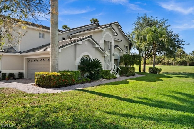 6095 Pinnacle Ln Unit 1304, Naples, FL 34110 - view of home's exterior with a garage, a tile roof, a lawn, and stucco siding
