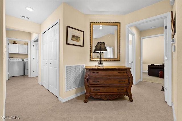 6095 Pinnacle Ln Unit 1304, Naples, FL 34110 - hallway with washing machine and clothes dryer, baseboards, visible vents, and light tile patterned floors
