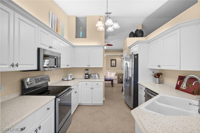 6095 Pinnacle Ln Unit 1304, Naples, FL 34110 - kitchen featuring a sink, a chandelier, light countertops, white cabinets, and appliances with stainless steel finishes