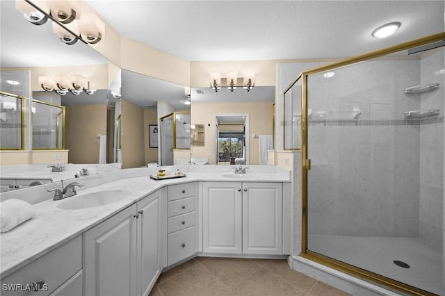 6095 Pinnacle Ln Unit 1304, Naples, FL 34110 - bathroom with double vanity, a shower stall, tile patterned floors, and a sink