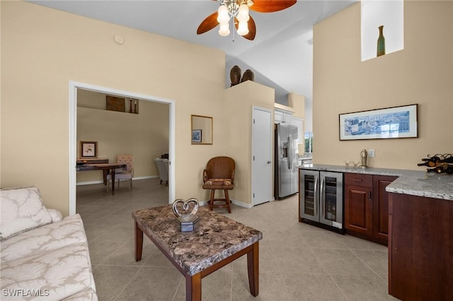 6095 Pinnacle Ln Unit 1304, Naples, FL 34110 - living area with beverage cooler, a ceiling fan, light tile patterned flooring, bar area, and high vaulted ceiling