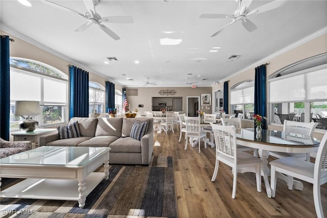 6095 Pinnacle Ln Unit 1304, Naples, FL 34110 - living area featuring wood finished floors, a healthy amount of sunlight, a ceiling fan, and ornamental molding