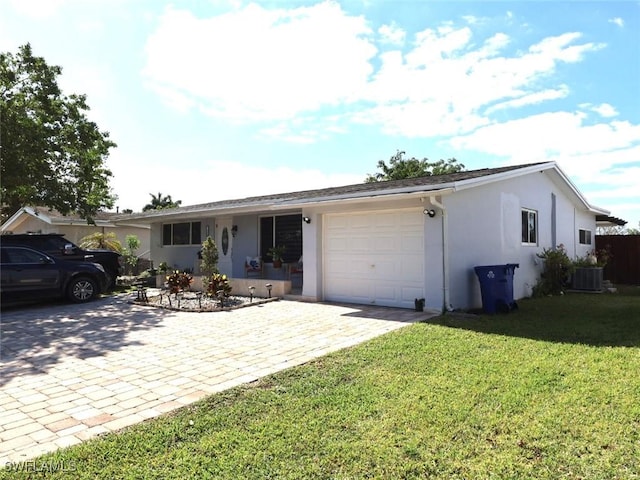 9170 24th Pl, Sunrise, FL 33322 - ranch-style home with a garage, stucco siding, a front lawn, and decorative driveway