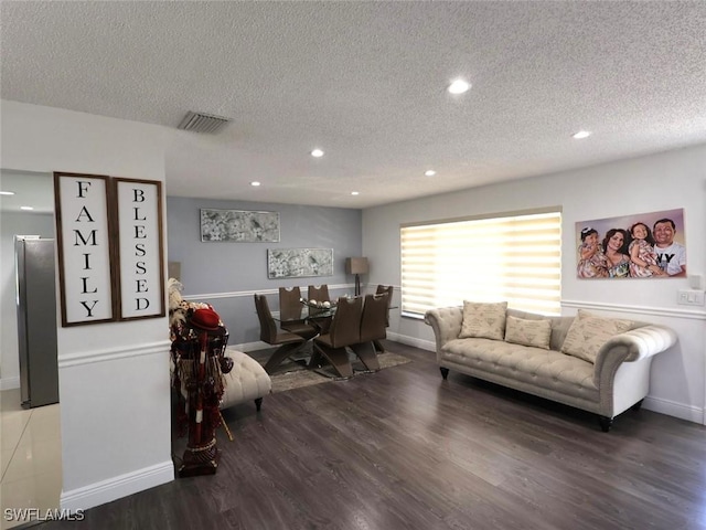 9170 24th Pl, Sunrise, FL 33322 - living area with a textured ceiling, wood finished floors, visible vents, and recessed lighting