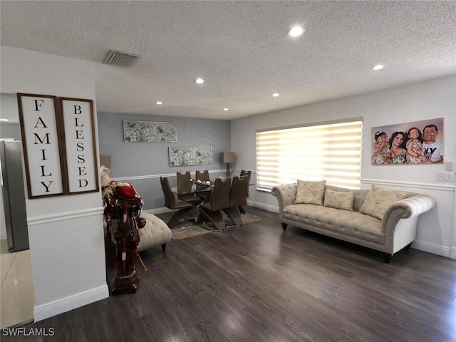 9170 24th Pl, Sunrise, FL 33322 - living area with visible vents, a textured ceiling, and wood finished floors
