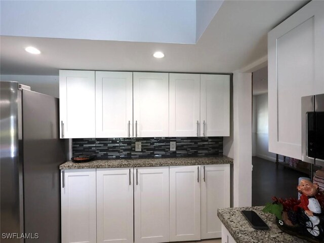 9170 24th Pl, Sunrise, FL 33322 - kitchen with white cabinets, appliances with stainless steel finishes, recessed lighting, backsplash, and stone countertops