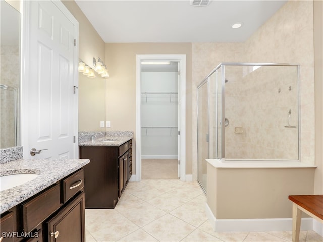 13530 Villa Di Preserve Ln, Estero, FL 33928 - bathroom with a stall shower, two vanities, and tile patterned flooring