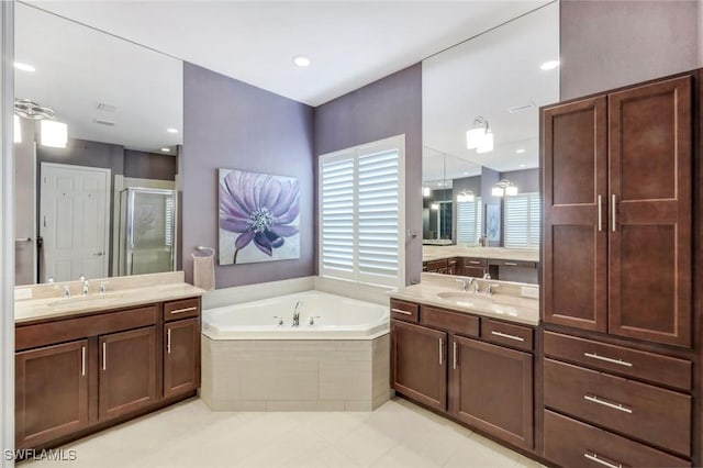 3267 Pacific Dr, Naples, FL 34119 - bathroom featuring a garden tub, a stall shower, two vanities, tile patterned floors, and recessed lighting