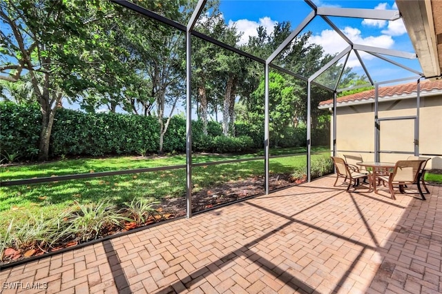 3267 Pacific Dr, Naples, FL 34119 - view of patio / terrace featuring glass enclosure and outdoor dining area