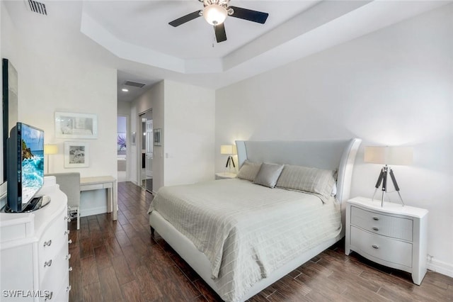 3267 Pacific Dr, Naples, FL 34119 - bedroom featuring wood finished floors, a tray ceiling, baseboards, and ceiling fan