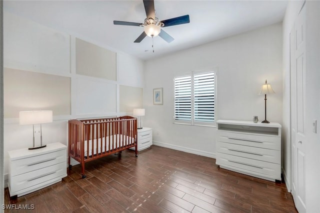 3267 Pacific Dr, Naples, FL 34119 - bedroom with wood finished floors, baseboards, a nursery area, and ceiling fan