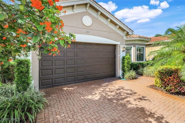 3267 Pacific Dr, Naples, FL 34119 - garage with decorative driveway