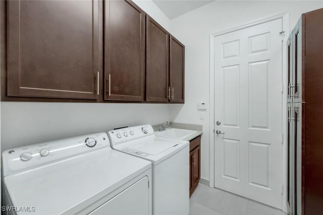 3267 Pacific Dr, Naples, FL 34119 - laundry area featuring cabinet space, washer and dryer, and light tile patterned flooring