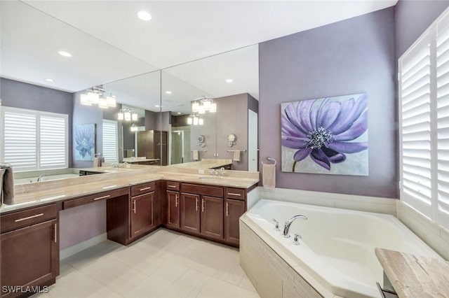 3267 Pacific Dr, Naples, FL 34119 - bathroom featuring plenty of natural light, double vanity, a bath, and recessed lighting