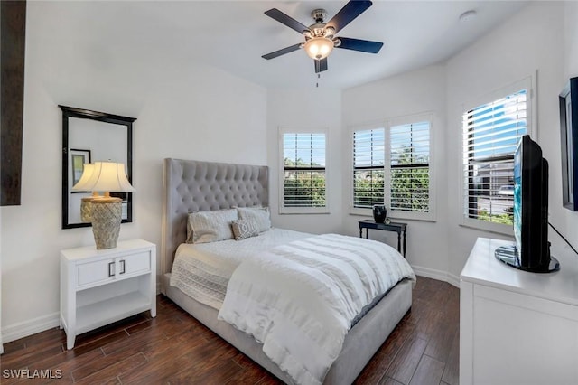 3267 Pacific Dr, Naples, FL 34119 - bedroom with multiple windows, dark wood-style flooring, and baseboards