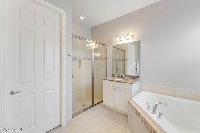 full bath with tile patterned floors, a garden tub, vanity, and a stall shower