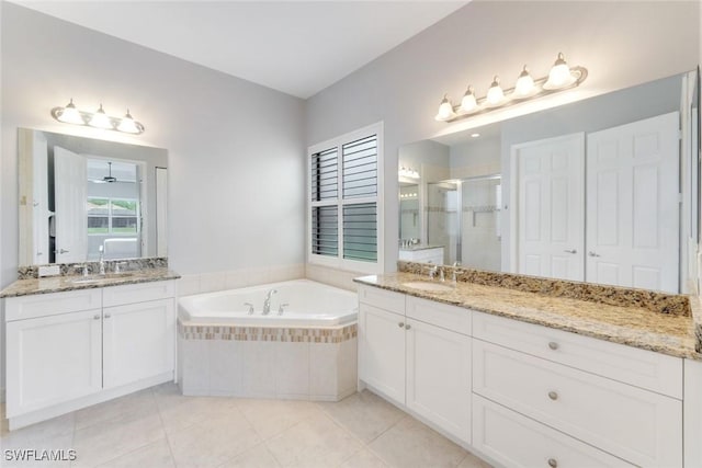 bathroom with a bath, a sink, two vanities, tile patterned flooring, and a shower stall