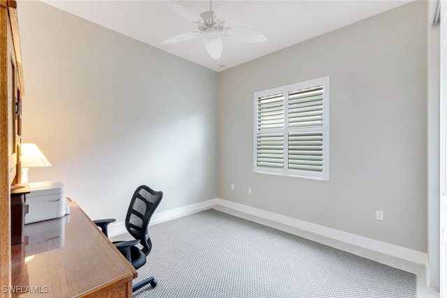carpeted office with baseboards and ceiling fan