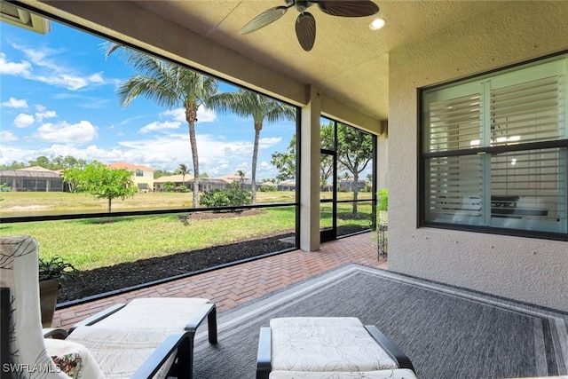 sunroom / solarium with ceiling fan