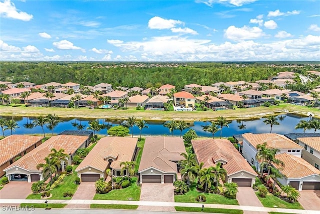 drone / aerial view with a residential view and a water view