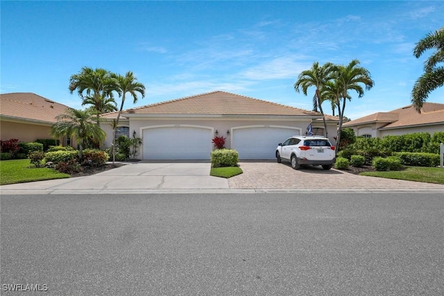 12732 Fox Ridge Dr, Bonita Springs, FL 34135 - single story home with a garage, driveway, a tiled roof, and stucco siding
