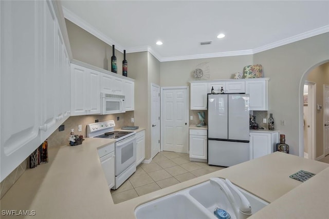 12732 Fox Ridge Dr, Bonita Springs, FL 34135 - kitchen with white cabinets, arched walkways, white appliances, and visible vents