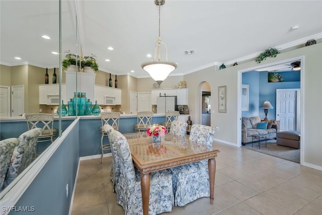 12732 Fox Ridge Dr, Bonita Springs, FL 34135 - dining space featuring crown molding, light tile patterned floors, arched walkways, visible vents, and recessed lighting