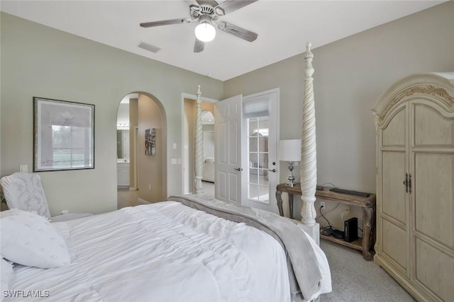12732 Fox Ridge Dr, Bonita Springs, FL 34135 - bedroom with ensuite bathroom, arched walkways, light colored carpet, a ceiling fan, and visible vents