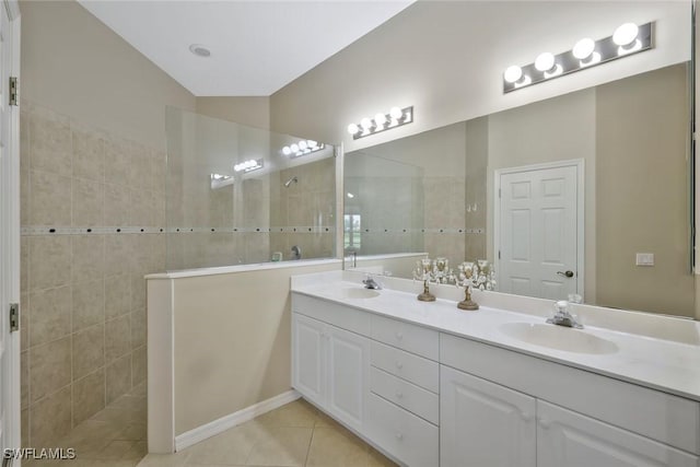 12732 Fox Ridge Dr, Bonita Springs, FL 34135 - bathroom with a sink, tile walls, a walk in shower, and tile patterned flooring