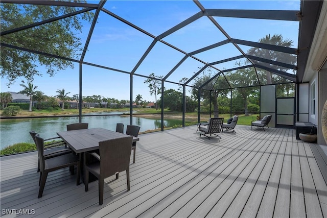 15890 Delasol Ln, Naples, FL 34110 - wooden deck with outdoor dining area, a water view, and a lanai