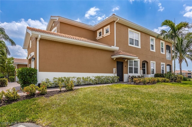 18276 Creekside Preserve Loop Unit 102, Fort Myers, FL 33908 - view of front of home featuring a front yard, stucco siding, and a tiled roof