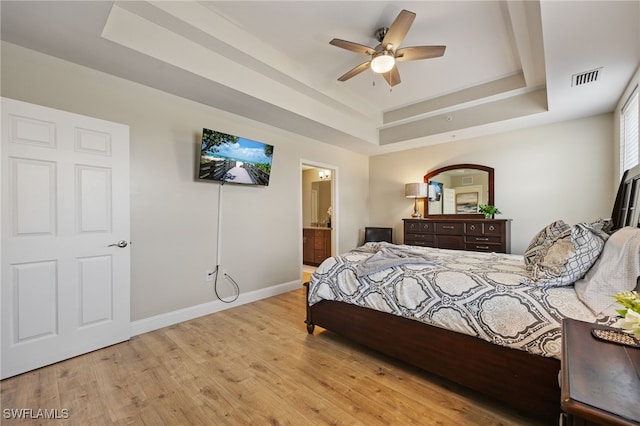 18276 Creekside Preserve Loop Unit 102, Fort Myers, FL 33908 - bedroom with a raised ceiling, wood finished floors, ensuite bath, and ceiling fan