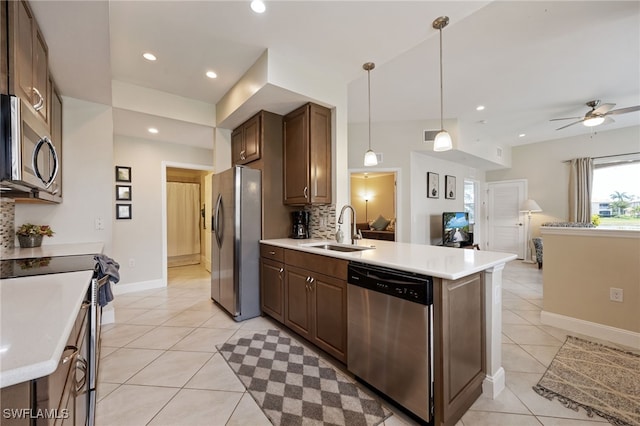 18276 Creekside Preserve Loop Unit 102, Fort Myers, FL 33908 - kitchen with appliances with stainless steel finishes, light tile patterned flooring, open floor plan, ceiling fan, and light countertops