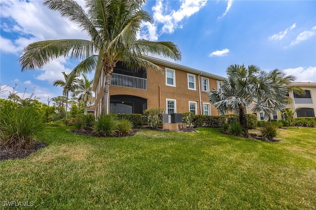 18276 Creekside Preserve Loop Unit 102, Fort Myers, FL 33908 - back of property with stucco siding and a yard