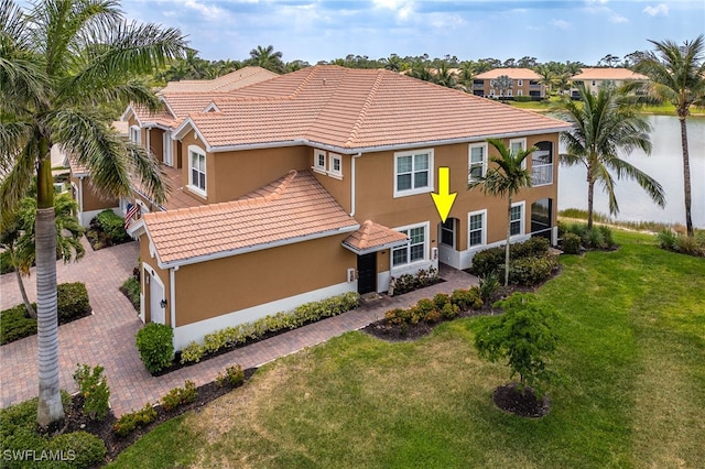 18276 Creekside Preserve Loop Unit 102, Fort Myers, FL 33908 - view of front of house featuring stucco siding, a tile roof, a front lawn, decorative driveway, and a garage