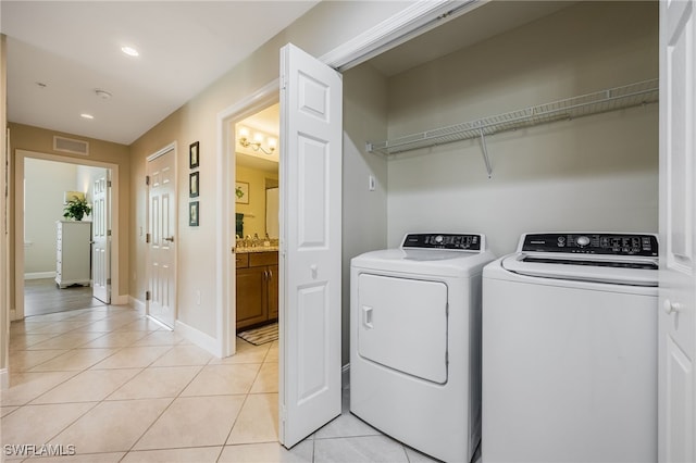 18276 Creekside Preserve Loop Unit 102, Fort Myers, FL 33908 - laundry area with washer and clothes dryer, light tile patterned floors, and recessed lighting