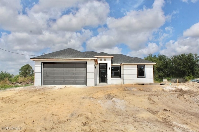 view of front of house with an attached garage and stucco siding