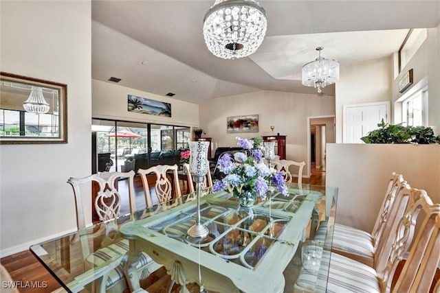 1803 Golfside Village Dr, Lehigh Acres, FL 33936 - dining area featuring a chandelier, wood finished floors, and vaulted ceiling