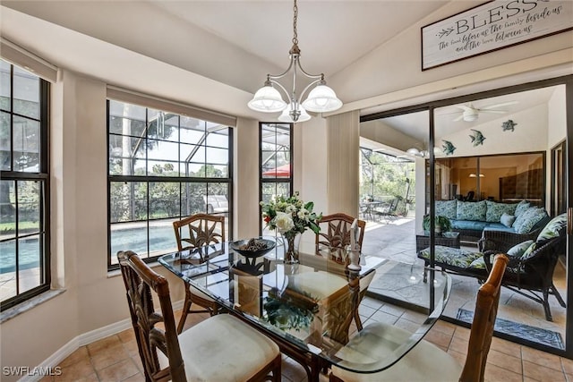 1803 Golfside Village Dr, Lehigh Acres, FL 33936 - dining room featuring lofted ceiling, light tile patterned floors, a sunroom, baseboards, and a chandelier