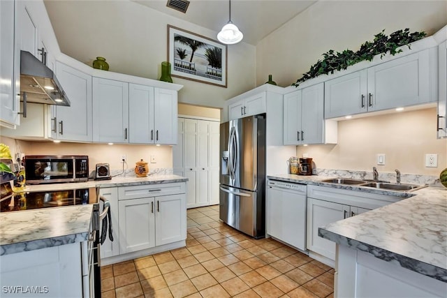 1803 Golfside Village Dr, Lehigh Acres, FL 33936 - kitchen with stainless steel appliances, a sink, extractor fan, light tile patterned floors, and light countertops