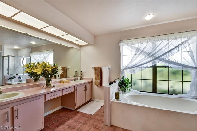 1803 Golfside Village Dr, Lehigh Acres, FL 33936 - full bathroom featuring tile patterned floors, double vanity, a stall shower, a garden tub, and baseboards