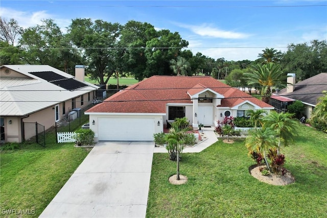 1803 Golfside Village Dr, Lehigh Acres, FL 33936 - mediterranean / spanish home with an attached garage and concrete driveway