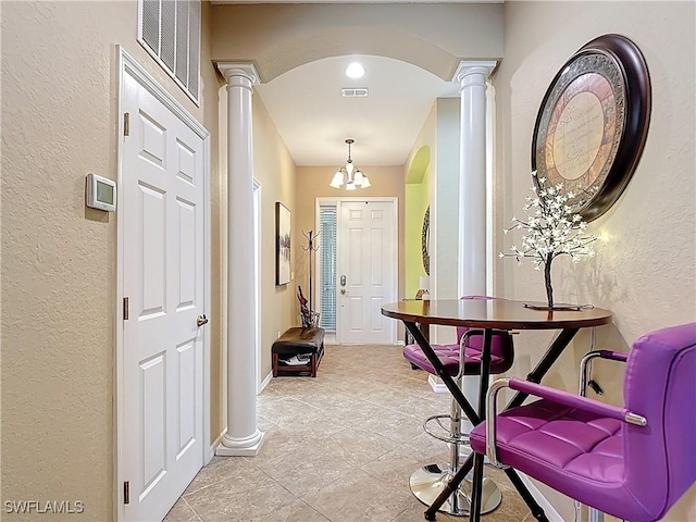13885 Cleto Dr, Estero, FL 33928 - interior space with visible vents, baseboards, arched walkways, a textured wall, and ornate columns