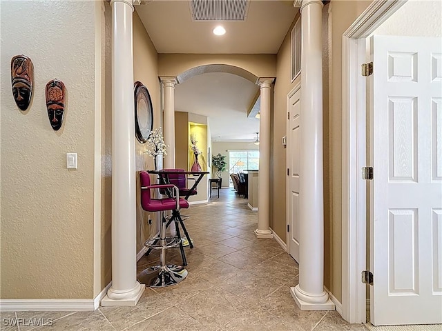 13885 Cleto Dr, Estero, FL 33928 - hallway featuring arched walkways, decorative columns, baseboards, and visible vents